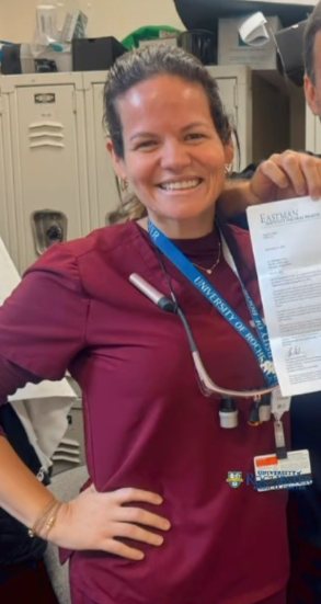 Dr. Raquel de Mello Gomes in scrubs in the dental clinic